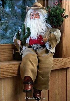 an old fashioned santa clause doll sitting on a window sill holding a potted plant