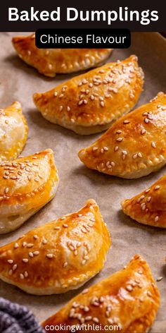 baked dumplings on a baking sheet with sesame seeds