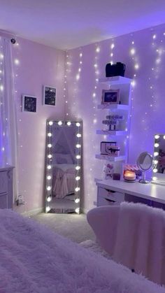 a bedroom with lights on the walls and white furniture