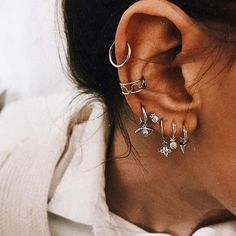 a close up of a person wearing ear piercings