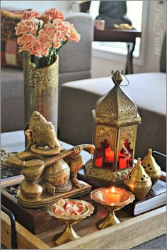 a tray with candles, tea lights and figurines sitting on top of it