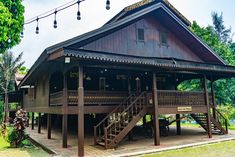 a wooden building with stairs leading up to the second floor and two story balconys