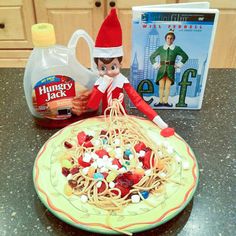 an elf is sitting in front of a plate of spaghetti