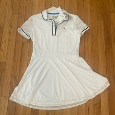 a women's white tennis dress on the floor