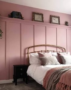 a bedroom with pink walls and white bedding