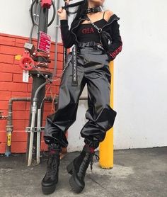 a woman standing next to a gas pump