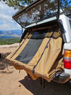 the back end of a white truck with an awning on it