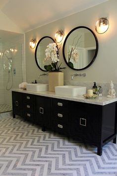 a bathroom with two sinks and three mirrors on the wall next to eachother