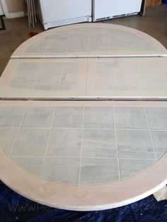 a round table being constructed with wood and tile