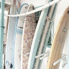 several surfboards are lined up against the wall