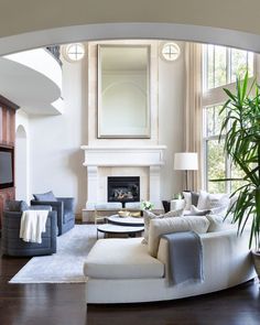 a living room filled with furniture and a large mirror on the wall over a fire place