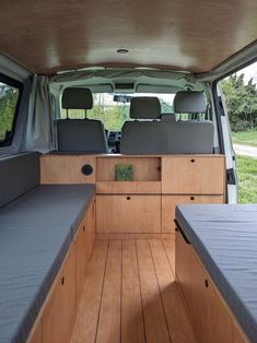 the interior of an empty van with two beds