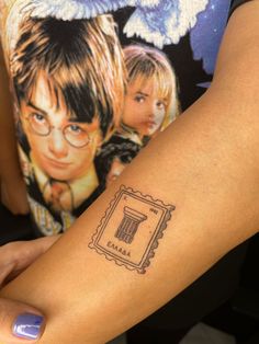 a woman with a harry potter tattoo on her arm