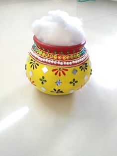 a yellow vase with a white cloud in it