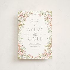 a wedding card with flowers and leaves on it