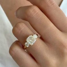 a woman's hand with a yellow and white diamond ring on top of her finger