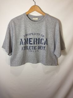 "MEDIUM \"Property of America Athletic Dept.\" cropped t-shirt in gray." Gray Cropped Cotton T-shirt With Short Sleeves, Urban Threads, Cropped Tube Top, Cropped T Shirt, Cropped Tee, 로고 디자인, Crop Tshirt, Crop Tee, Tube Top