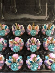 cupcakes decorated in pastel colors with gold, blue and pink frosting