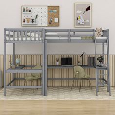 a loft bed with desk underneath it in a room that has wood floors and beige walls