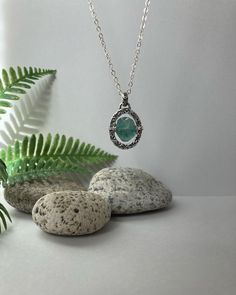 This handmade necklace displays a blue-green Roman glass bead wired to a stamped sterling silver frame.  It is suspended from an 18-inch sterling chain and clasp:  primitive but delicate! Necklace Displays, Roman Glass, Ancient Romans, Rustic Elegance, Handmade Necklace, Silver Frame, Colorado Springs, Sterling Silver Necklace, Glass Bead