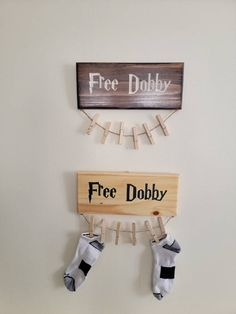 there is a sign that says free dobby and two socks hanging from clothes pins