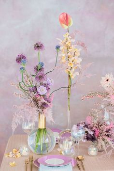 the table is set with purple and yellow flowers