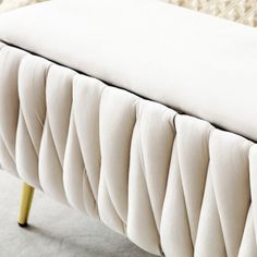 a close up view of a bed with white sheets and pillows on it's headboard