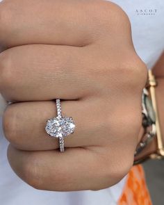 a woman's hand with a diamond ring on it