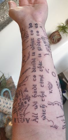 a person's arm with writing on it, and the words written in different languages