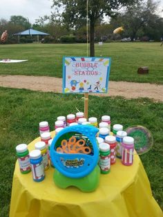 there is a table with bottles on it and a sign that says bubble starz