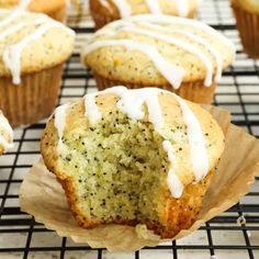 a muffin with white icing sitting on top of a cooling rack