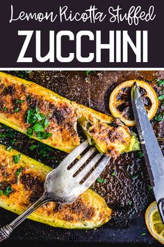 lemon ricotta stuffed zucchini on a baking sheet with a knife and fork