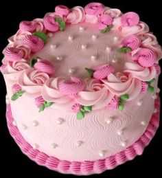 a cake with pink frosting and flowers on it