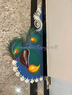 an artistic painting on the side of a door with peacock feathers and flowers painted on it