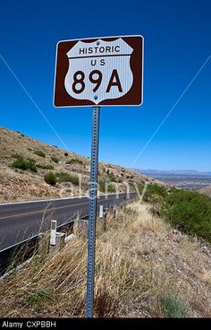 a road sign on the side of a hill