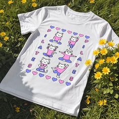 Add some cuteness to your workout wardrobe with our Pilates Cat Shirt and Sweatshirt featuring an adorable cats doing pilates! ⭐Unisex Sweatshirt⭐ *50% cotton, 50% polyester *Medium-heavy fabric *Regular fit for a comfortable feel *Tear-away label  *Size up for trendy oversized look  ⭐Unisex Short Sleeve T-Shirt⭐ * Lightweight fabric *Runs true to size *Tear-away label *Size up for trendy oversized look  *Perfect for active and leisure wear *Made with 100% Airlume combed and ring-spun cotton ⭐Ca Playful Stretch Crew Neck Top, Playful White Stretch Top, Casual Short Sleeve Tops For Pilates, White Cartoon Print Sports Top, Crew Neck Stretch T-shirt For Pilates, White Cartoon Print Tops For Sports, White Relaxed Fit Top With Cat Design, Playful Sports Tops With Letter Print, Playful Cat Design Crew Neck T-shirt