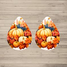 two paper plates decorated with pumpkins and autumn leaves on a wooden surface, one has an image of a turkey