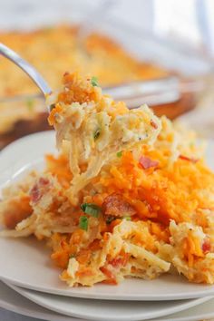 a white plate topped with hash browns covered in cheese