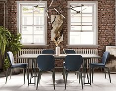 a dining room with brick walls and blue chairs around a white table surrounded by plants