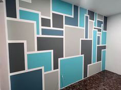 a room with blue and gray squares painted on the wall