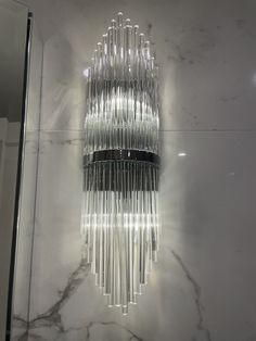 a chandelier hanging from the ceiling in a bathroom