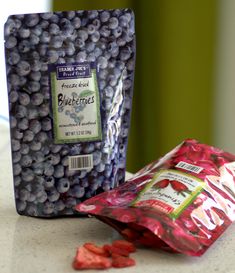 two bags of blueberries sitting on top of a counter