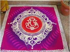 an intricately designed mat with gandapa on it in front of a potted plant