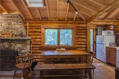 a kitchen and dining area in a log cabin