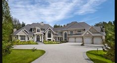 a large house with lots of windows and landscaping