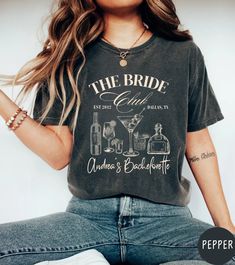 Celebrate your bride-to-be with our beautifully designed and personalized "The Bride Club" t-shirt, perfect for gifting bridesmaids! This Comfort Colors 1717 garment-dyed t-shirt offers both style and comfort, making it an ideal choice for pre-wedding events or as a cherished keepsake. Customization:   This t-shirt features a chic cocktail and social theme illustration with the text "The Bride Club." Customize it with:    Bride's name    Wedding or party date    Wedding or party location    Choi Custom Bachelorette Shirts, Cocktail Club, Personalized Matches, Girls Trip Shirts, Bachelorette Shirts, Wedding Party Favors, Travel Shirts, Matching Shirts, Dye T Shirt