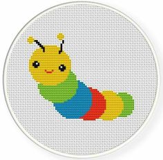 a cross stitch caterpillar is shown on a white circle with an orange, yellow and green stripe