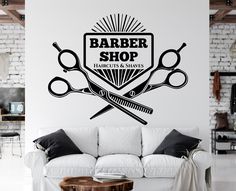 a barber shop wall decal with scissors and combs on it's side