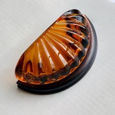 an orange glass object sitting on top of a table