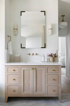 a bathroom vanity with two sinks and a large mirror